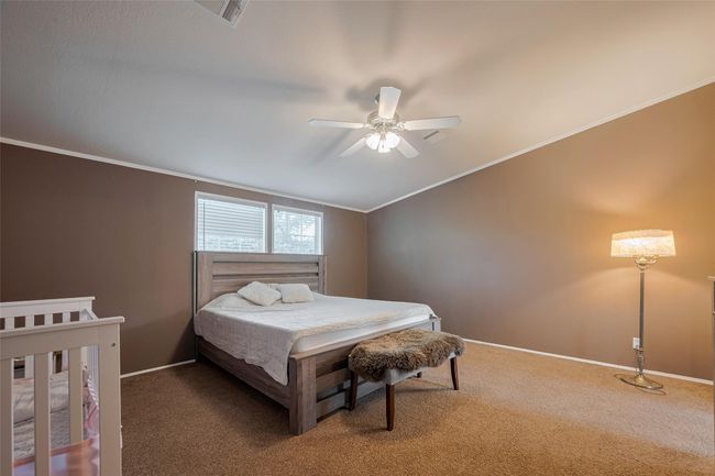 Another bedroom that is well-lit with a ceiling fan that adds to the ambiance. | Image 26
