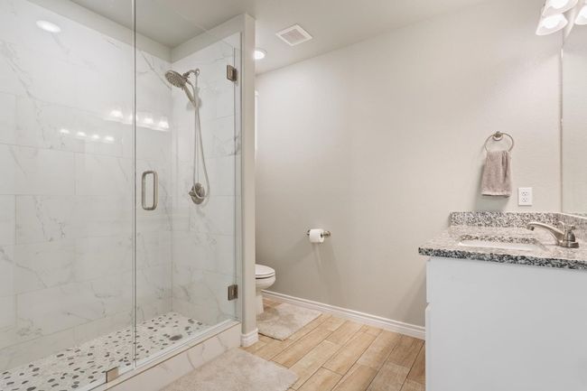 Full bathroom featuring a stall shower, vanity, and wood finished floors | Image 20