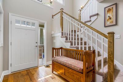 Entrance foyer with wood-type flooring and a towering ceiling | Image 3