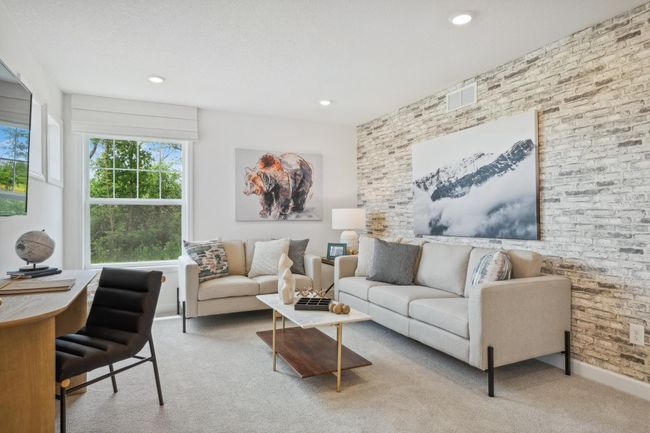 Photo is of the actual model. Located on the upper level, this perfectly sized living space has enough room for a desk, television and seating for all. Plus, it is just steps away from all four upper level bedrooms. | Image 12