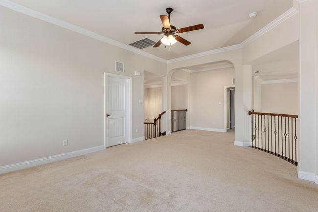 Unfurnished room with a ceiling fan, ornamental molding, visible vents, and carpet | Image 31