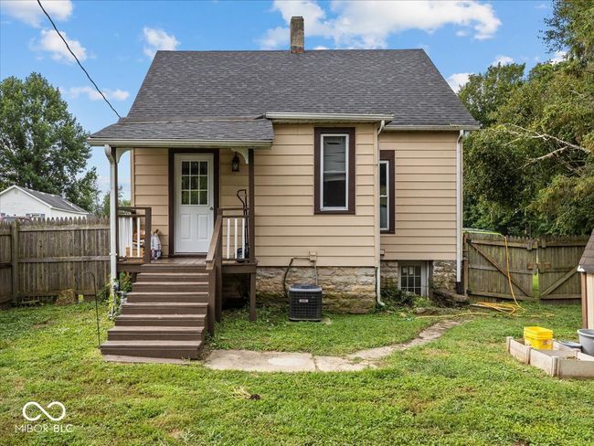 back of property featuring a chimney, a fenced backyard, and a shingled roof | Image 31