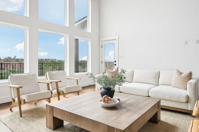 Living area featuring a towering ceiling and wood finished floors | Image 9