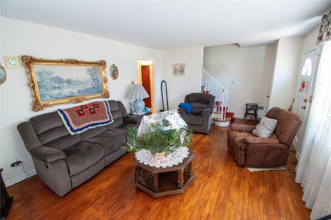Living area featuring stairway and wood finished floors | Image 17