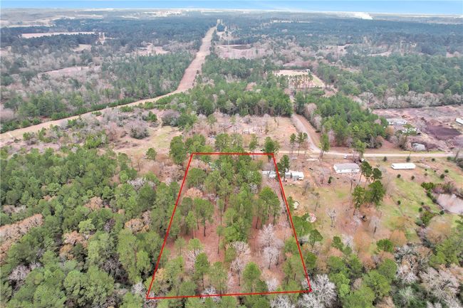 Aerial overview of property's location with property boundaries highlighted and a heavily wooded area | Image 40