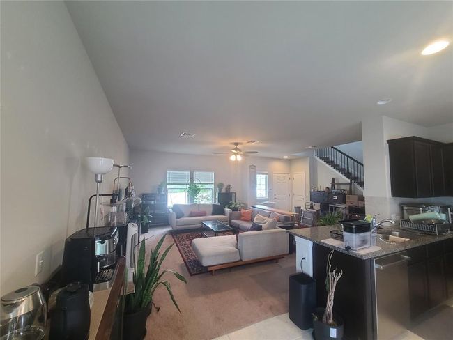 Living area featuring a ceiling fan, recessed lighting, light carpet, and stairway | Image 4