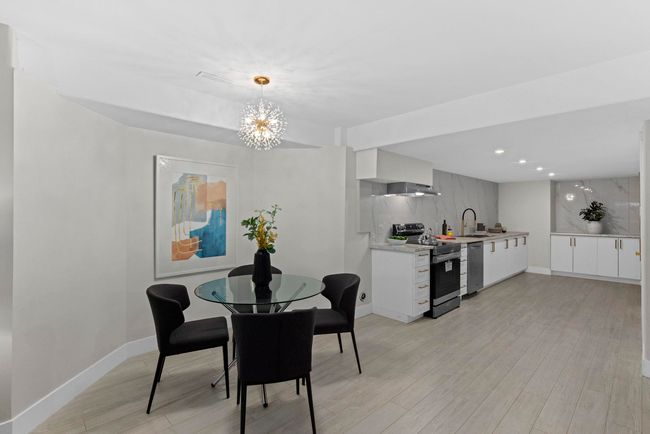 Dining space with baseboards, light wood-type flooring, a notable chandelier, and recessed lighting | Image 32