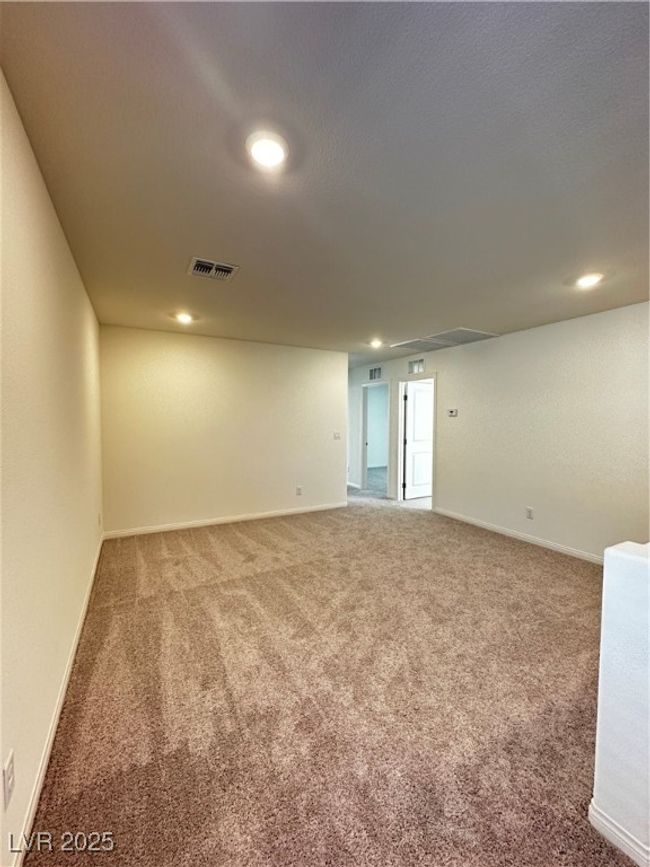 Carpeted empty room featuring recessed lighting, visible vents, and baseboards | Image 12