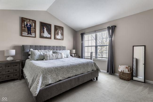 Primary bedroom with walk in closet & another closet. Vaulted ceilings and lots of natural light. | Image 16
