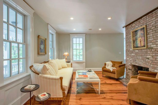 Living area with hardwood / wood-style flooring, a brick fireplace, and recessed lighting | Image 5