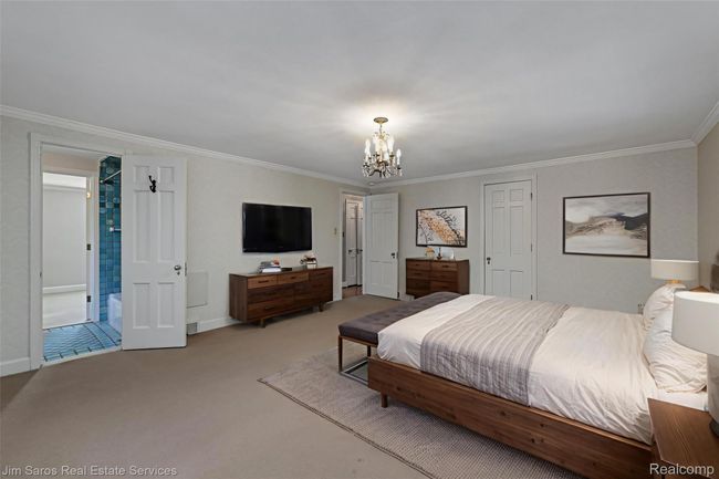 Carpeted bedroom featuring ornamental molding and a chandelier | Image 16