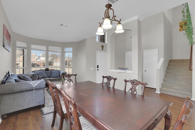 Dining area featuring dark wood-style flooring, visible vents, and stairway | Image 22