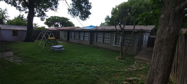 Back of property with stucco siding and a playground | Image 34