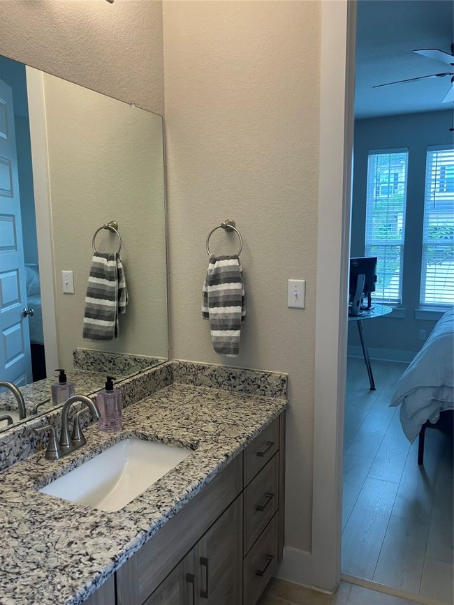 Bathroom with vanity, a ceiling fan, and baseboards | Image 19