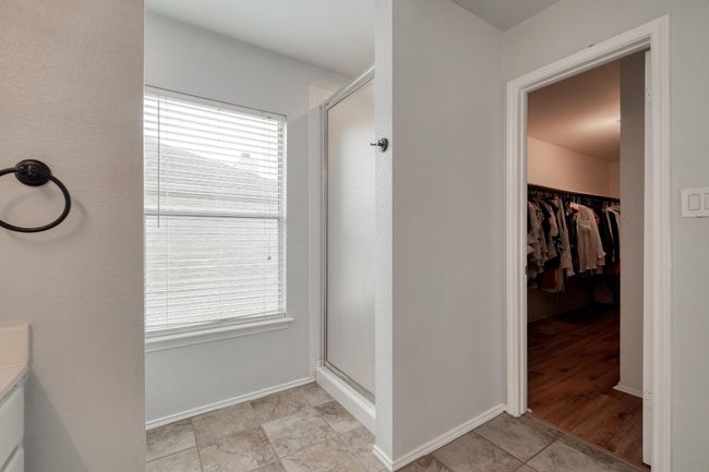 Bathroom with a stall shower and a walk in closet | Image 24