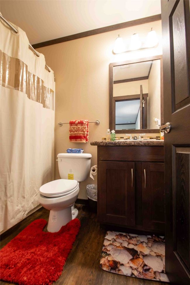 Full bathroom featuring toilet, wood finished floors, vanity, a shower with curtain, and ornamental molding | Image 22