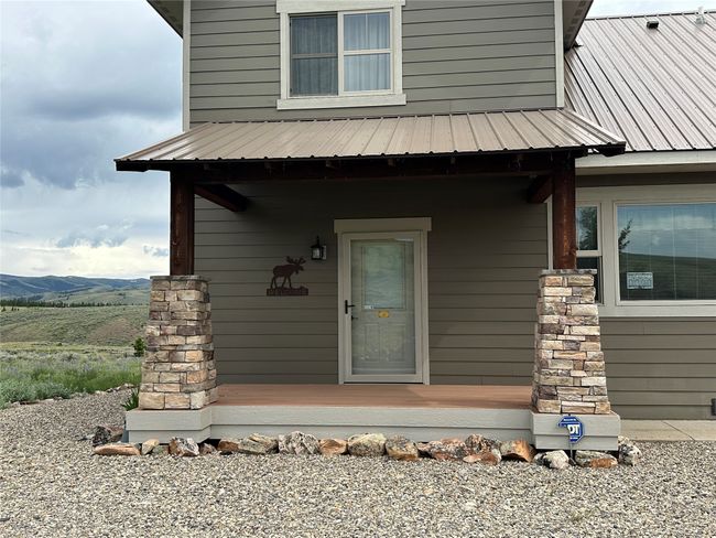 View of exterior entry featuring a metal roof and a mountain view | Image 33