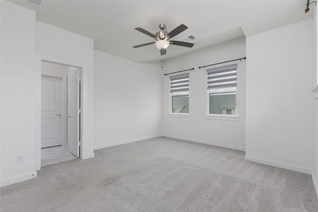 Spare room with a ceiling fan and carpet floors | Image 15