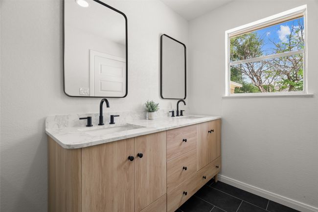 Full bathroom featuring double vanity, tile patterned floors, and baseboards | Image 17