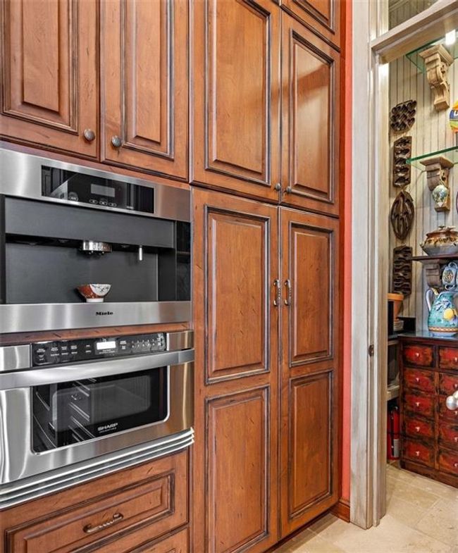 Before entering the butler's pantry you wil find a built-in pantry w/a pull out spice rack. | Image 16