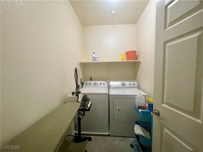 Laundry area with laundry area, washing machine and clothes dryer, and tile patterned flooring | Image 44