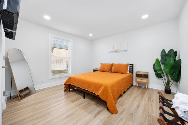 Bedroom with light wood-style flooring, baseboards, and recessed lighting | Image 37