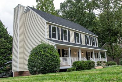 Colonial home featuring a front lawn and covered porch | Image 3