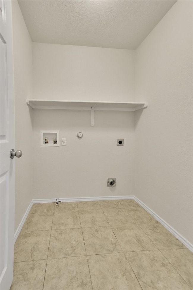 Washroom featuring electric dryer hookup, baseboards, gas dryer hookup, laundry area, and washer hookup | Image 21