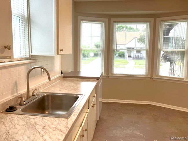 Eat-in kitchen, freshly painted, new vinyl flooring. | Image 9