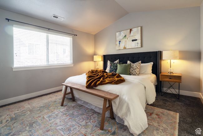 Bedroom with lofted ceiling, carpet, and baseboards | Image 9