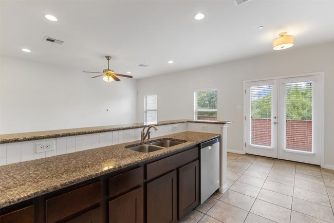Kitchen with dishwasher, healthy amount of natural light, dark brown cabinets, and recessed lighting | Image 13
