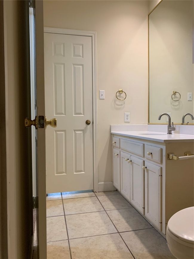 Bathroom featuring tile patterned flooring, toilet, and vanity | Image 4