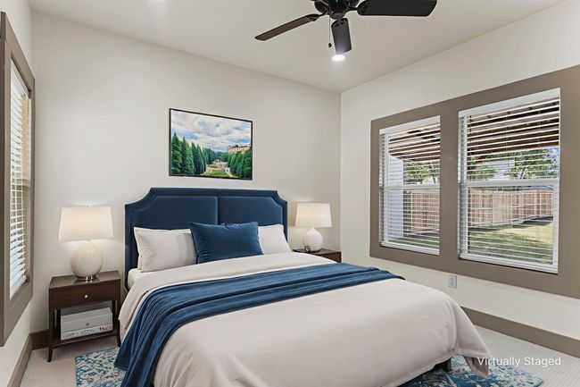 Carpeted bedroom featuring a ceiling fan and baseboards | Image 28