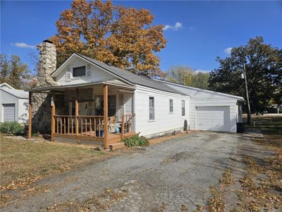 View of front of home with covered porch and a garage | Image 2