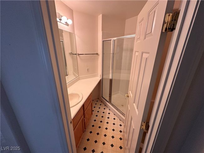 Full bathroom with a stall shower, vanity, and tile patterned floors | Image 9