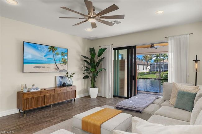 Living room featuring dark hardwood / wood-style flooring and a water view | Image 4