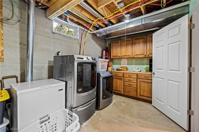 Laundry room with cabinets and washing machine and dryer | Image 41