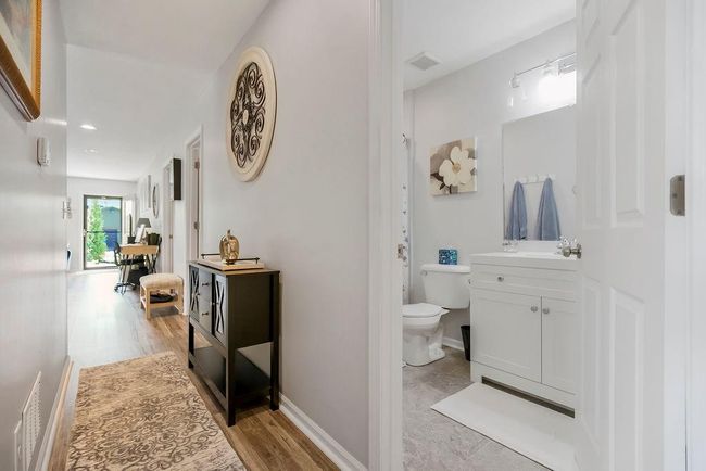 Bathroom with wood finished floors, visible vents, toilet, and vanity | Image 25