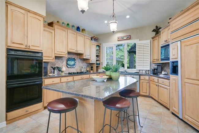Kitchen featuring a breakfast bar and center island | Image 12