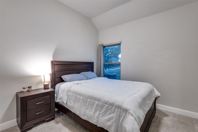 Bedroom with light carpet, lofted ceiling, and baseboards | Image 22