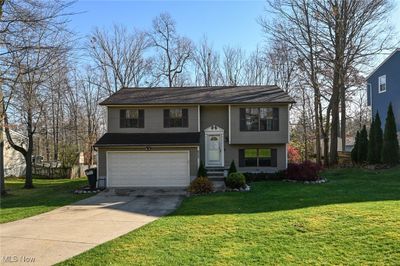 Bi-Level featuring a front yard and a garage | Image 2