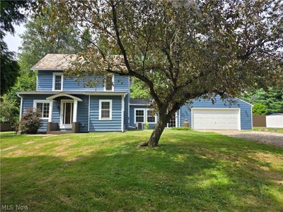 View of front of home with a garage, an outbuilding, and a front lawn | Image 3