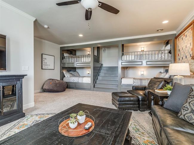Living room featuring carpet, visible vents, ornamental molding, baseboards, and stairs | Image 25