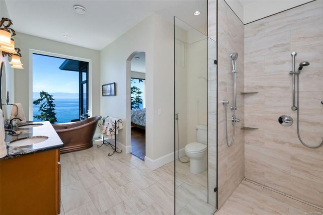 Bedroom with wood finished floors, recessed lighting, ceiling fan, and a water view | Image 10