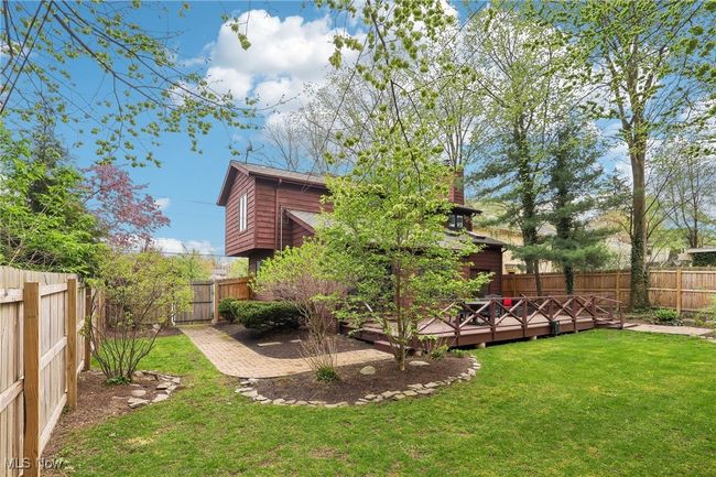 View of yard featuring a wooden deck and a fenced backyard | Image 39