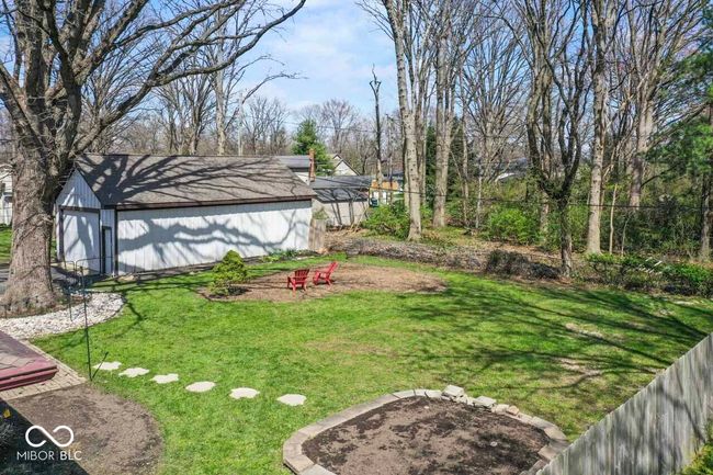 view of yard featuring an outbuilding, fence, and a fire pit | Image 32