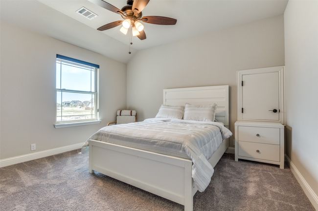 Bedroom featuring carpet, lofted ceiling, and a ceiling fan | Image 30