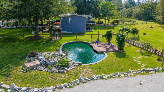 View of pool featuring stairs and a deck | Image 37