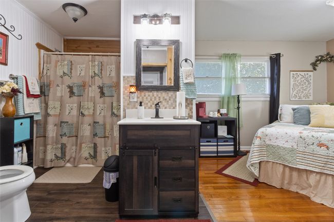 Bedroom featuring dark wood-style floors and ornamental molding | Image 18