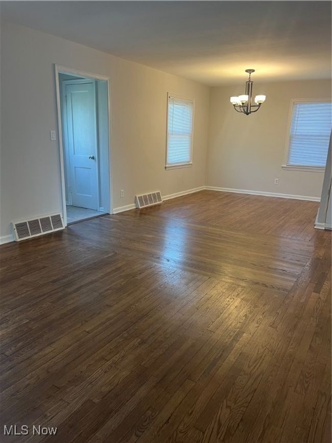 Dining room with a chandelier and hardwood floor | Image 4